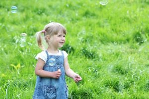 little girl with soap bubbles