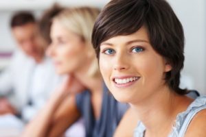 Closeup of pretty young woman with blur people in background